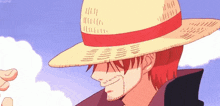 a man with red hair is wearing a straw hat and a black jacket .