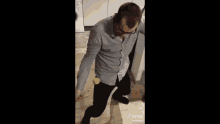 a man in a kitchen is holding a hammer and a ball and says tiktok on the bottom