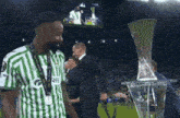 a man in a green and white striped shirt with the word ree on the front