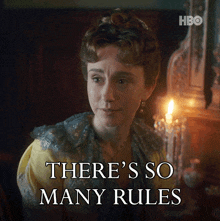 a woman says there 's so many rules in front of a lit candle