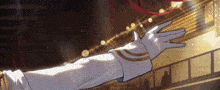 a person wearing white gloves is reaching out towards the camera