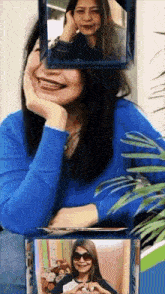 a woman in a blue shirt is smiling and making a heart shape