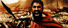 a man with a beard is holding a sword in his hand
