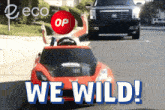 a red toy car with the words we wild on the bottom