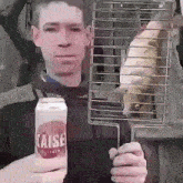 a man holding a can of raise juice