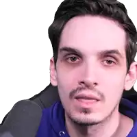 a close up of a man 's face with a microphone behind him