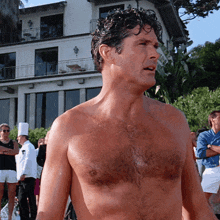 a shirtless man is standing in front of a building