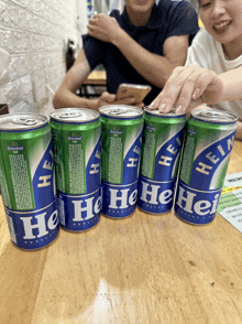 several cans of heineken beer are lined up on a table