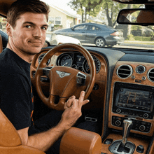 a man is sitting in a bentley car and giving the middle finger