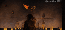 a man looking through binoculars at a dragon flying in the sky with the hashtag @avantika_0902
