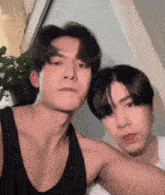 two young men are posing for a picture together