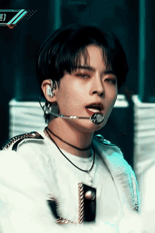 a close up of a person wearing a microphone and a necklace