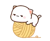 a white cat is laying on top of a ball of yarn