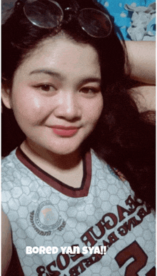 a woman wearing a jersey that says bored yan sya on it