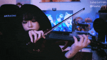 a woman playing a violin in front of a screen that says luna lorrain