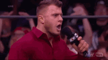 a man in a red shirt is holding a microphone in front of a crowd and says `` your opinions '' .