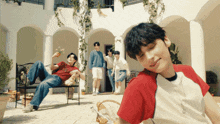 a group of young men are gathered in a courtyard