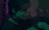a woman is smoking a cigarette in a dark room with chains in the background