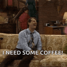 a man is sitting on a couch with the words " i need some coffee "