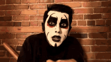 a man with black and white makeup on his face