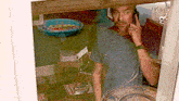 a man is talking on a cell phone behind a window