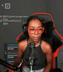 a woman wearing headphones and red glasses is sitting in front of a microphone with the name criminalpluto32 written on the screen