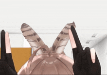 a close up of a person 's hands with a feather in the background
