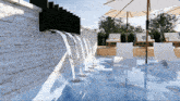 a swimming pool with umbrellas and chairs and a waterfall