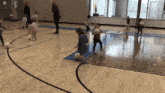 a group of children are playing with soccer balls on a court