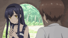 a girl with a skull and crossbones on her hair stands next to a man