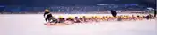 a group of people are sledding down a snow covered slope