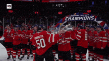 a hockey player in a canada jersey holds up a trophy