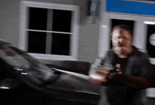 a blurry image of a man standing in front of a window