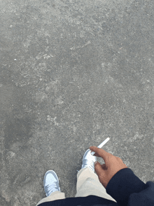 a person holding a cigarette in their right hand