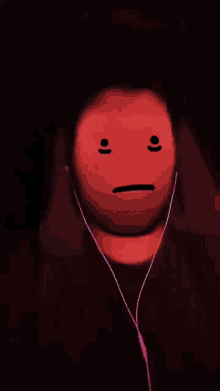 a person wearing headphones has a green face on their face