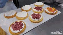 a bunch of cakes on a tray with the words made in animotica on the bottom right