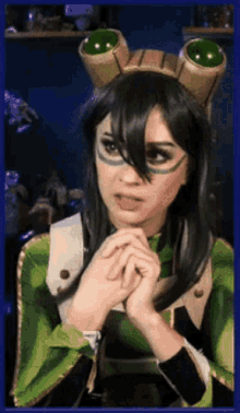 a woman in a frog costume is making a face