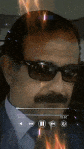 a man wearing sunglasses and a mustache is playing a video with the time of 03:00