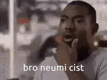 a man is thinking with his hand on his chin and the words bro neumi cist written on the bottom of the image .