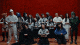 a group of people are posing for a picture and one of them is wearing a school uniform with the letter s on it