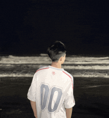 a man wearing a white shirt with the number 00 on the back