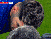 a close up of a man 's head with a score of 4 to 0 in the background