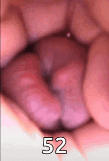 a close up of a person 's mouth with the number 52 written on it