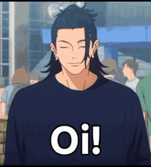a man wearing a blue shirt with the word oi on it is standing in front of a crowd of people .