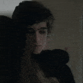 a close up of a man 's face with a woman behind him