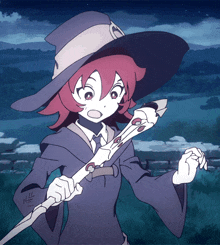 a girl in a witch costume holds a wand