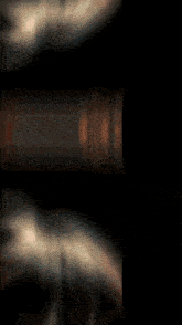 a blurred image of a woman 's face with a black background