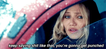 a woman is sitting in a car with the words keep saying shit like that you 're gonna get punched