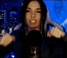 a woman wearing headphones and a microphone is making a face