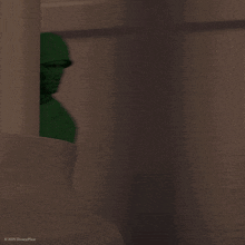 a green toy soldier from disney pixar is pointing his gun
